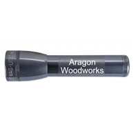 Gray ML25LT LED two-cell C flashlight with Aragon Woodworks engraving.
