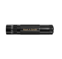 Black XL50 LED 3-Cell AAA flashlight with gold engraving reading Mark A Smith