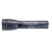 ML25LT LED 2-Cell C flashlight in gray with custom engraving along the barrel.
