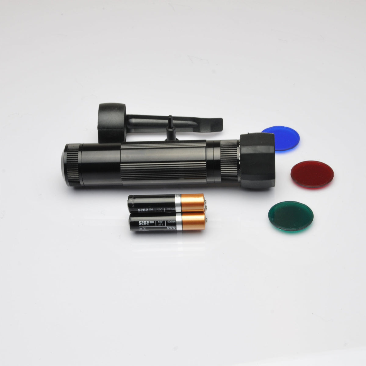Close up of the B2B XL50 LED tactical light with a blue end cap beside the body on a white background.