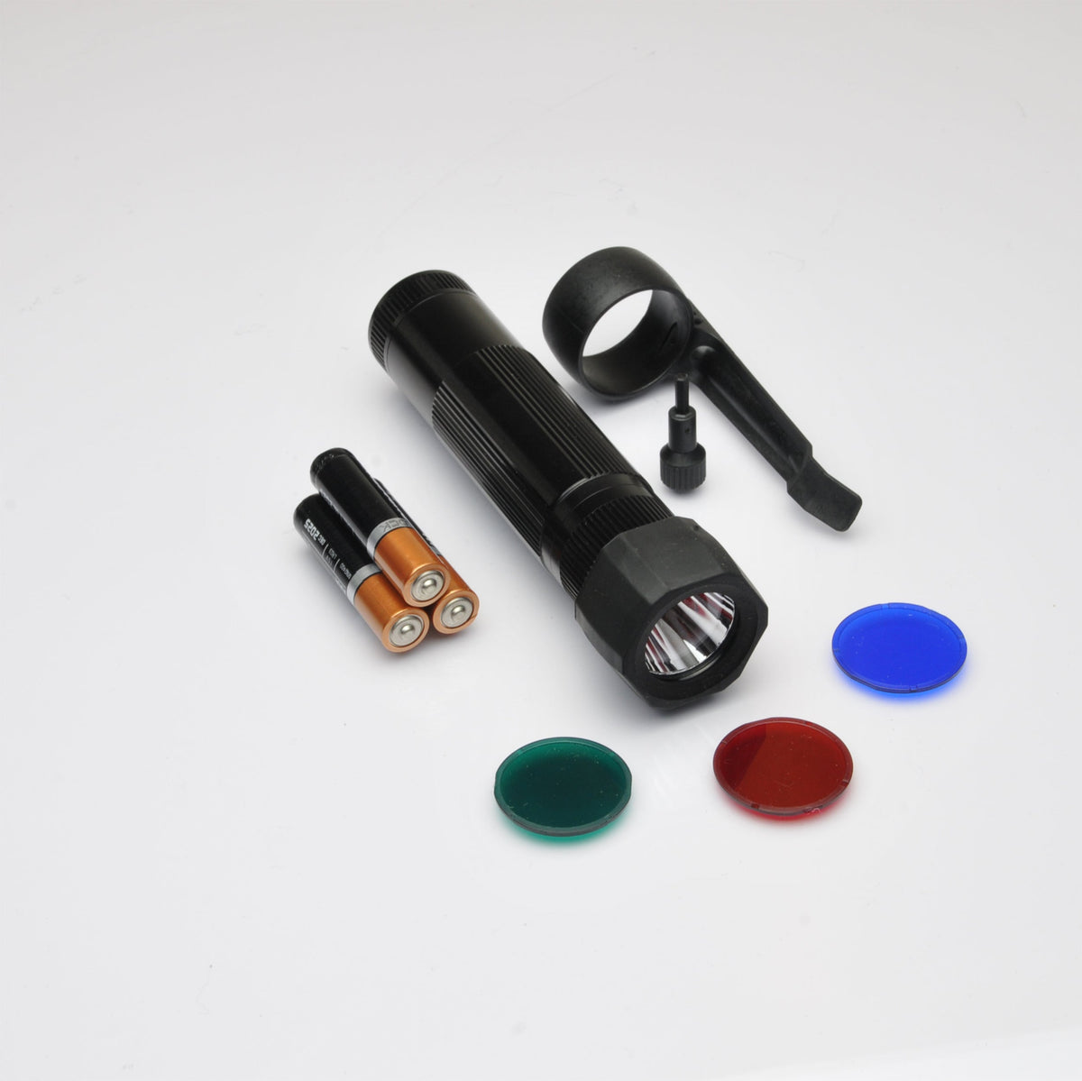 B2B XL50 LED Tactical Pack components with orange AA batteries and the flashlight body on a white surface.