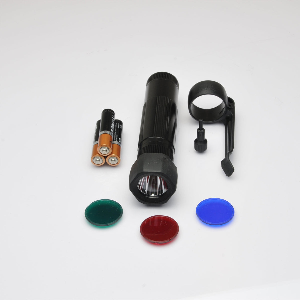 Close up of the black XL50 flashlight head with knurled grip on a white surface