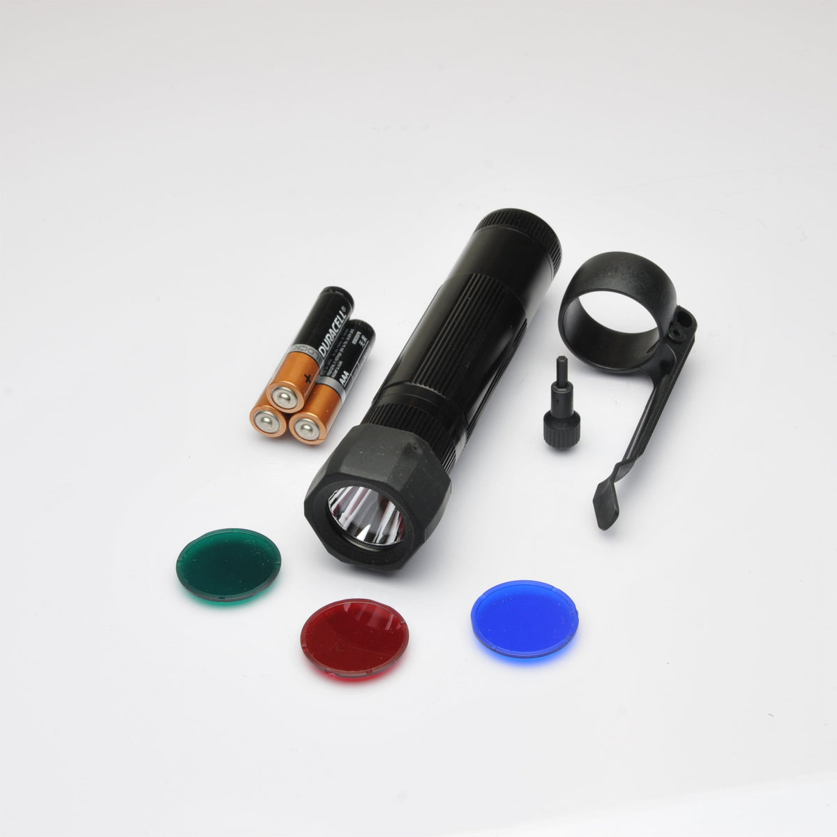 Disassembled XL50 flashlight with visible wiring and green red blue caps scattered around