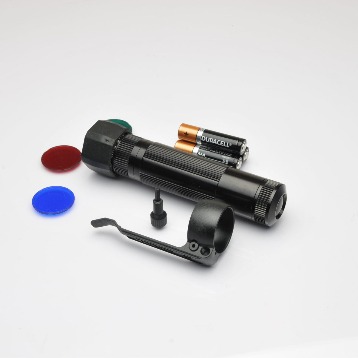 Black XL50 LED tactical flashlight with orange Duracell AAA batteries and red and blue end caps on a white surface
