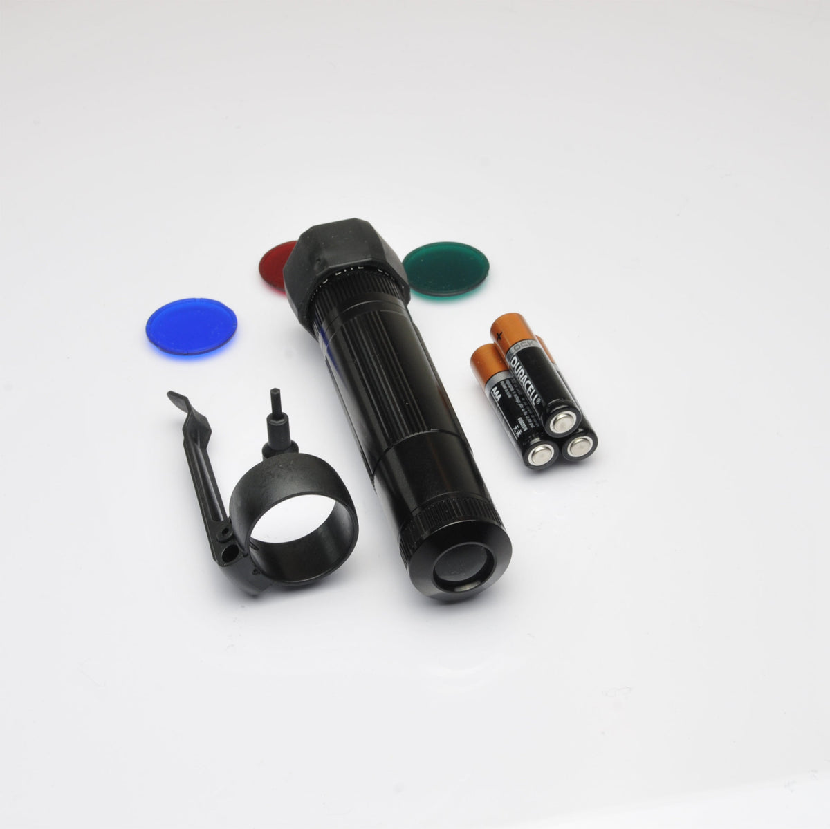 Black XL50 LED tactical flashlight with scattered blue red green and orange discs on a white background