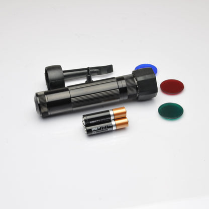 Partial view of the B2B XL50 LED tactical flashlight with blue and red caps on a white background.