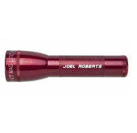 Red ML25LT two-cell C flashlight with custom engraving along the barrel