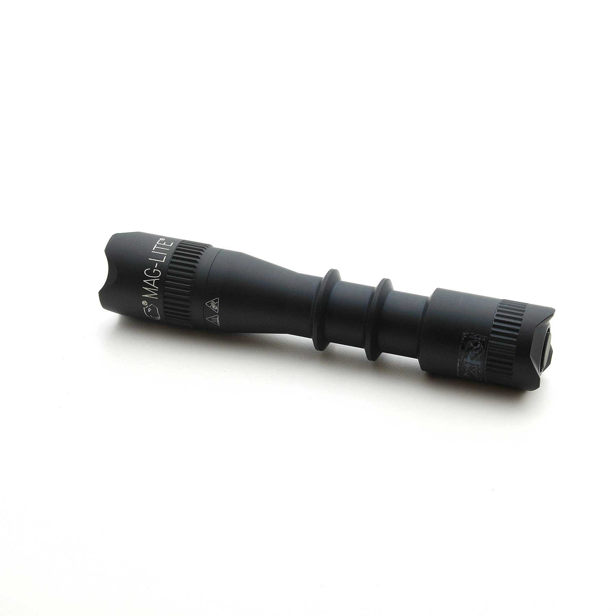 Black MAG-TAC 2 TM tactical flashlight with crown bezel and textured grip.