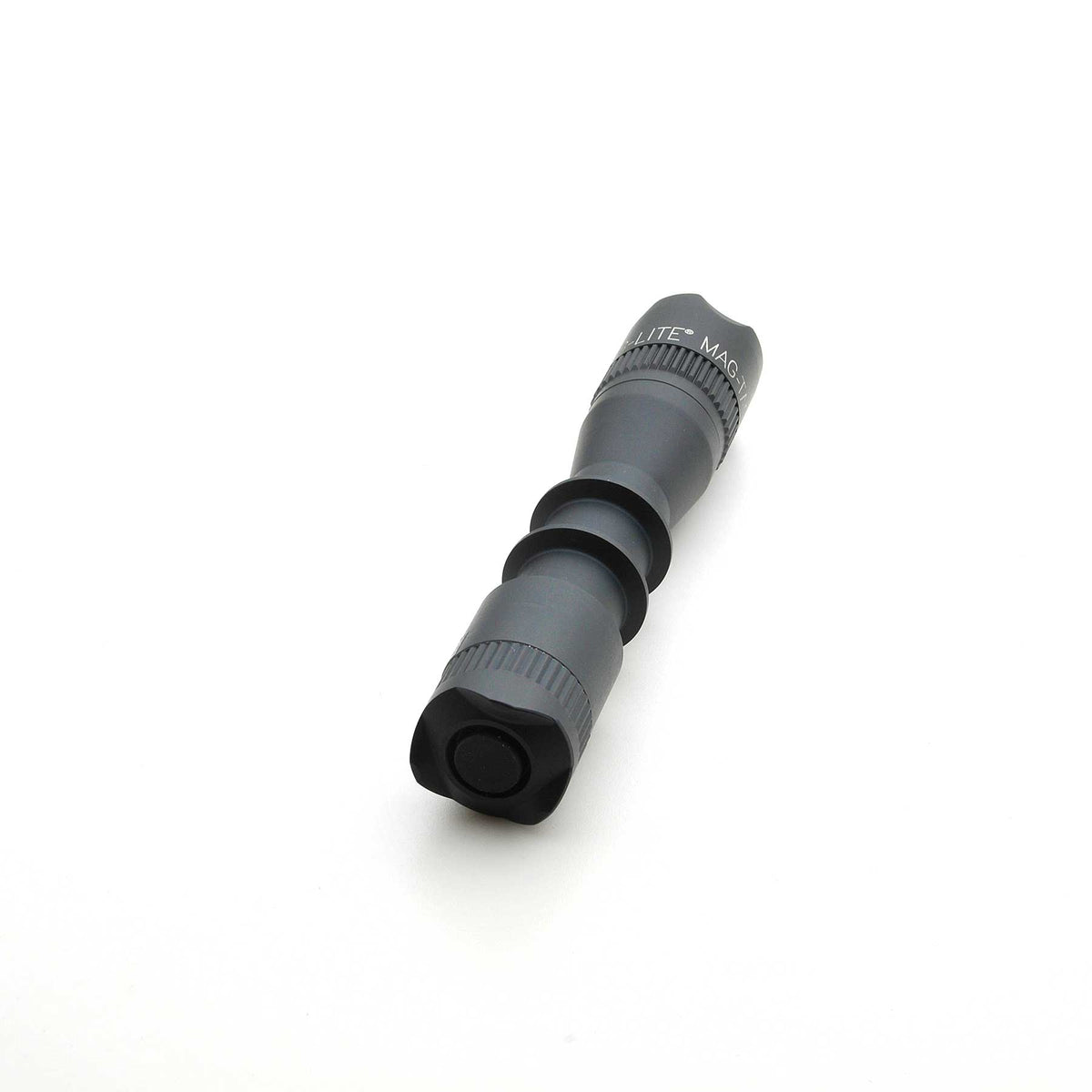 Close-up of MAG-TAC 2 TM Black Crown Bezel with knurled ring on a gray cylindrical body