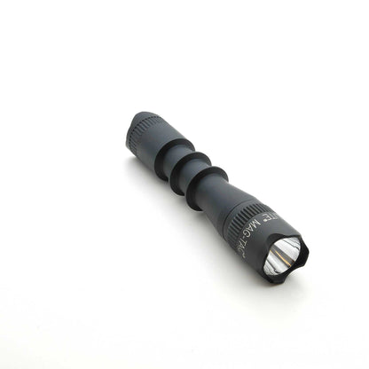 Black MAG-TAC 2 TM flashlight with crown bezel and knurled grip on white background.