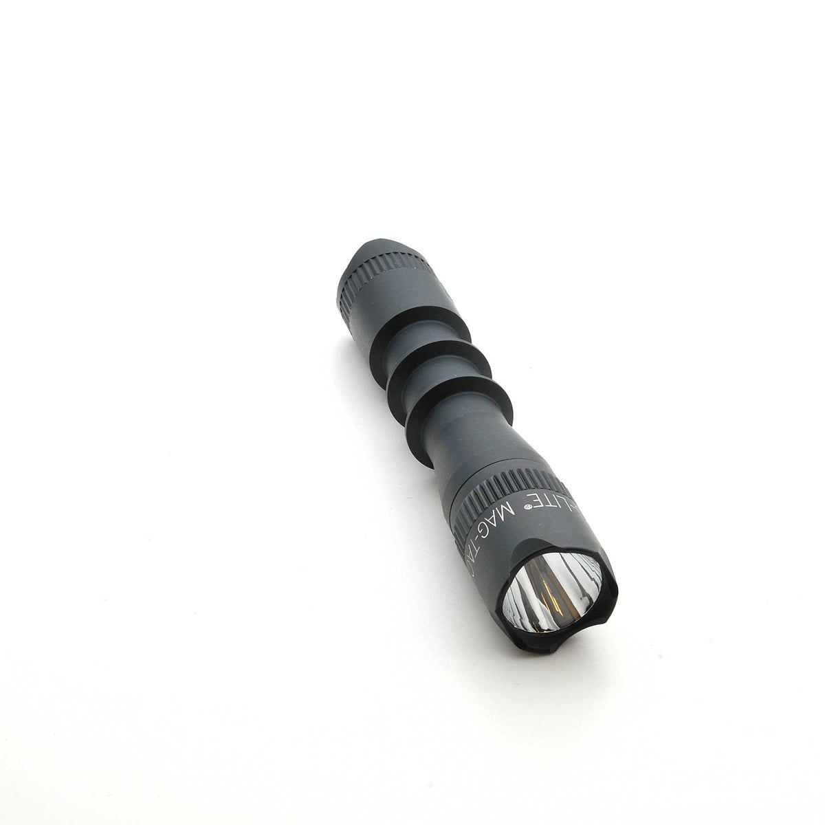 Side view of black MAG-TAC 2 TM crown bezel flashlight showing knurled focus ring.