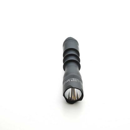 Front end of black MAG-TAC 2 TM crown bezel flashlight with clear lens and visible internal reflector.
