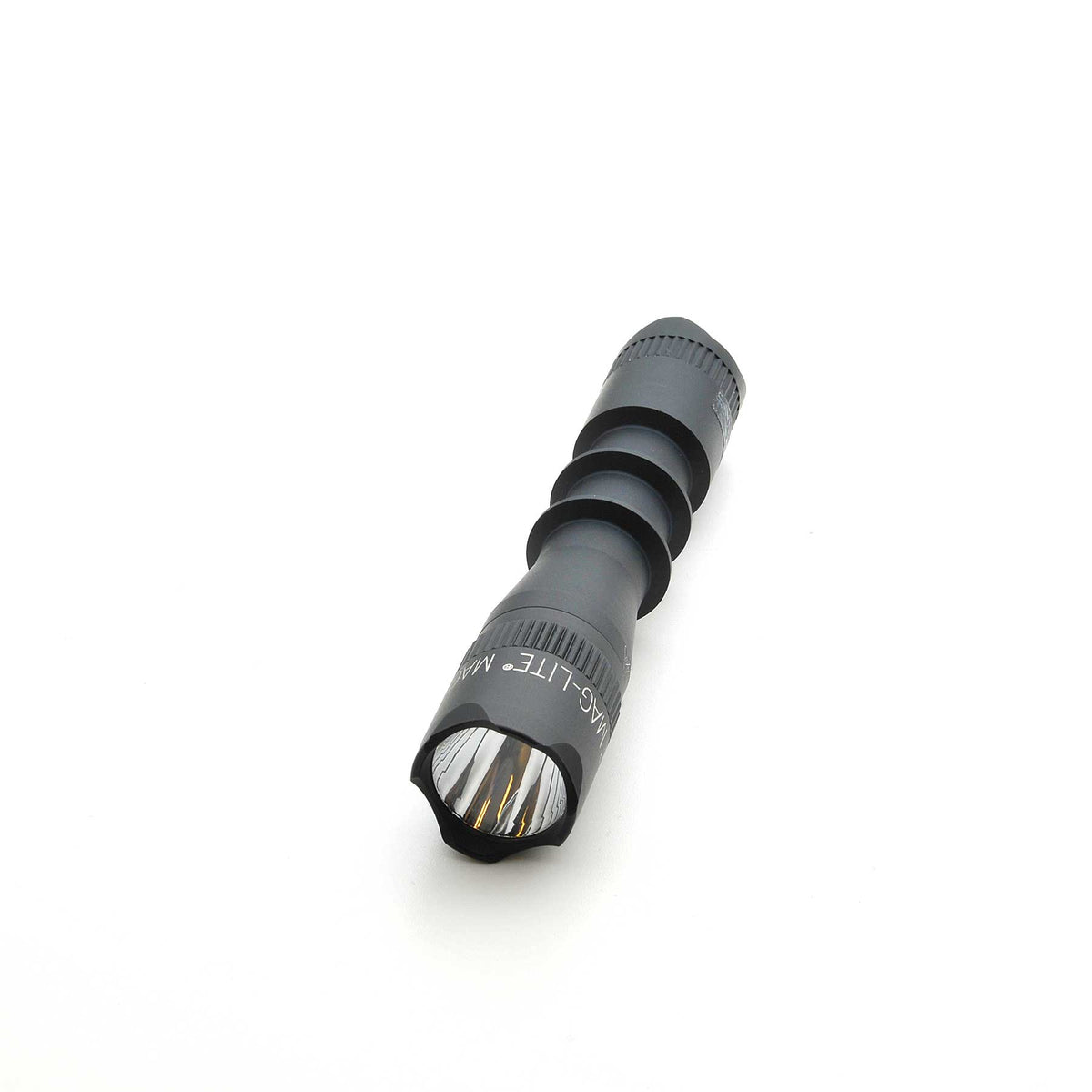 Diagonal view of MAG-TAC 2 flashlight in gray with black crown bezel and front lens