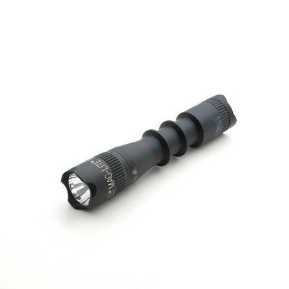 Close up of MAG-TAC 2 flashlight showing front lens and crown bezel on gray body