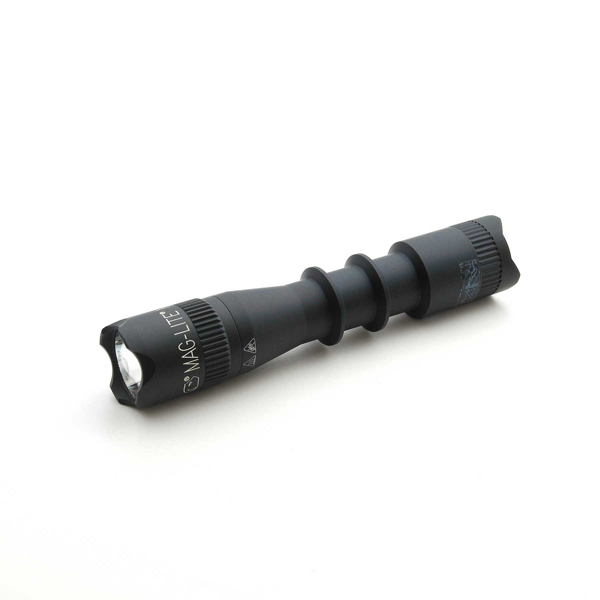 Black Mag-Tac 2TM tactical flashlight with crown bezel on white background