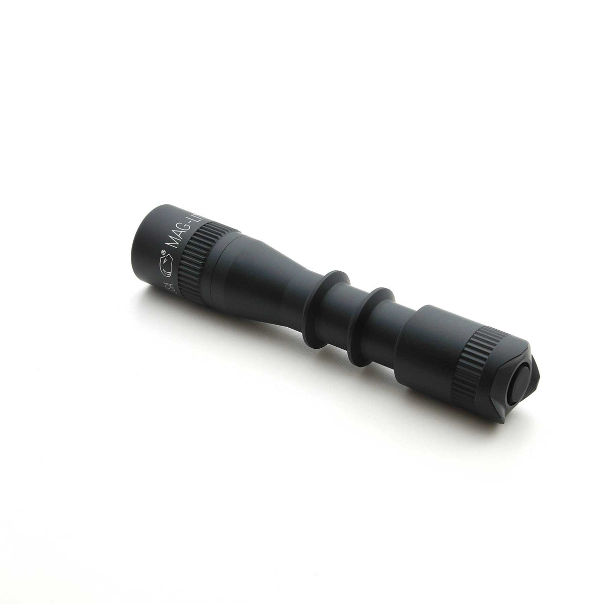 Close-up of black MAG-TAC 2 TL flashlight highlighting ridged grip and end cap.