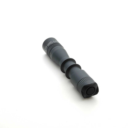 Diagonal view of MAG-TAC 2 TL Black plain bezel flashlight showing knurled collar and matte finish