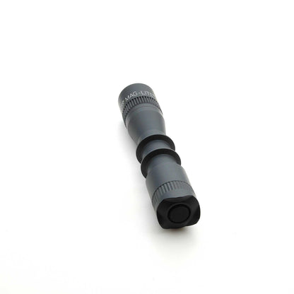 Angled side view of MAG-TAC 2 TL Black plain bezel flashlight highlighting textured grip and bezel
