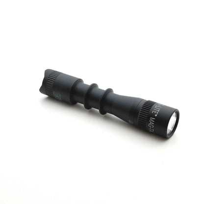 Front angled view of MAG-TAC 2 TL black plain bezel flashlight with clear lens and white branding along the barrel.