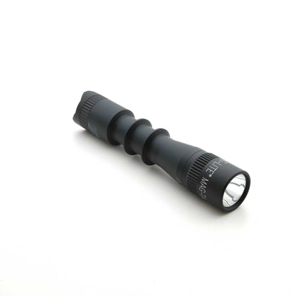 MAG-TAC 2 TL black tactical flashlight with plain bezel and knurled grip, angled on a white background.