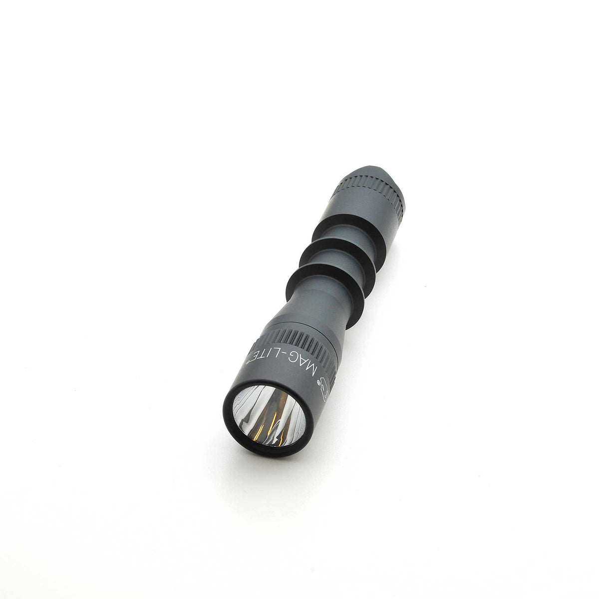 Side view of MAG-TAC 2 TL Black Plain Bezel flashlight with stacked cylinder sections and textured grip.