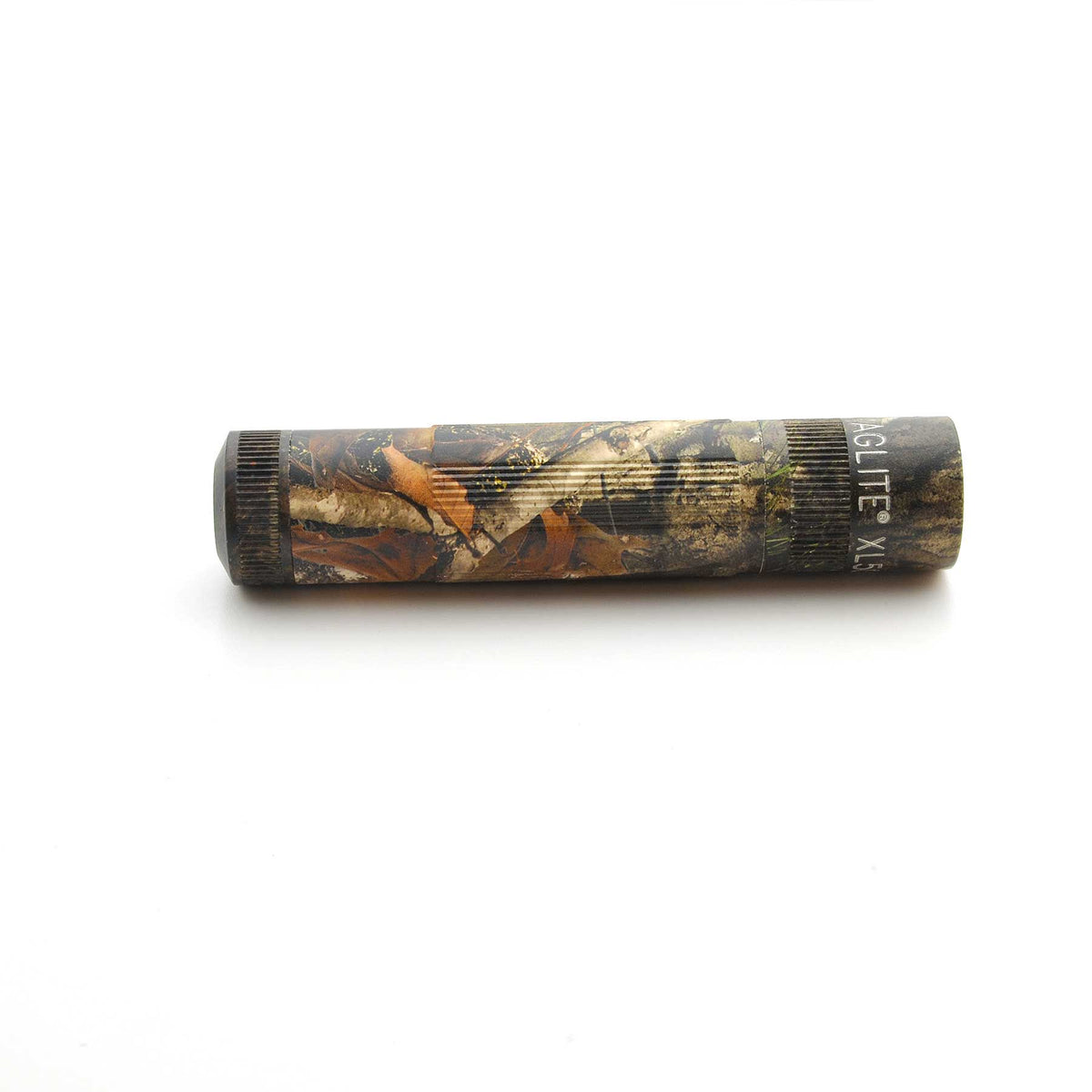 Maglite XL50 flashlight in Mossy Oak New Country DNA pattern resting on a white background