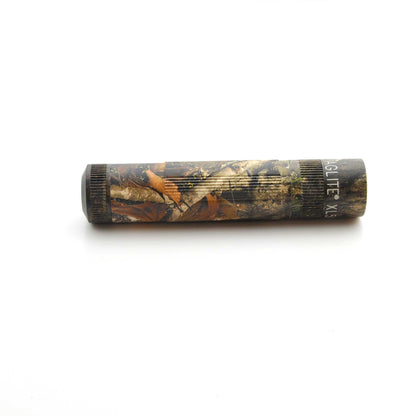Maglite XL50 flashlight in Mossy Oak New Country DNA pattern resting on a white background