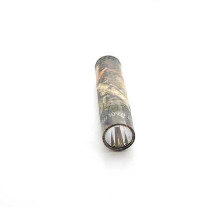 Maglite XL50 flashlight in Mossy Oak New Country DNA camouflage with lens visible at the bottom