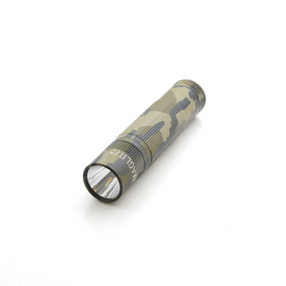 Maglite XL50 flashlight in Mossy Oak Original Bottomland camouflage with the lens end visible, angled diagonally.