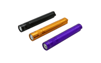 Halloween assortment of three Maglite Solitaire flashlights in black orange and purple on a green background