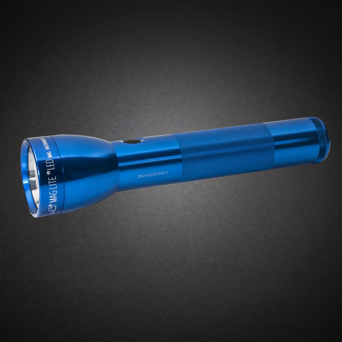 Blue ML300L LED 2-Cell D flashlight with knurled grip shown diagonally on a dark surface
