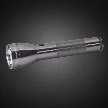 Gray ML300L LED 2-Cell D flashlight with knurled grip shown diagonally on a dark surface