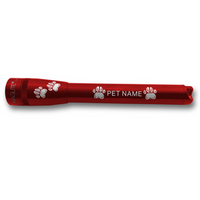 Red Maglite Pro LED flashlight with paw print engravings and PET NAME along the barrel.