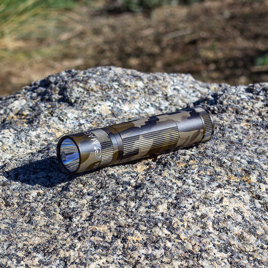 Open hard case with camouflage Maglite XL50 and Energizer Max AA batteries inside