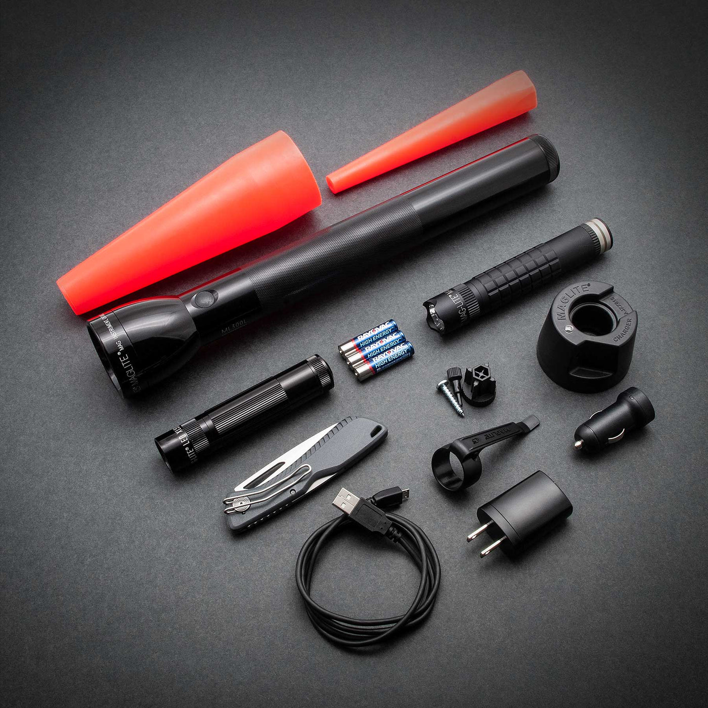 Maglite ML300L 4D LED, Maglite XL50 LED, Maglite MAG-TAC LED Rechargeable System, a red safety wand for the XL50 and the ML300L, three AAA premium alkaline batteries and a pocket clip for the XL50 Flashlight. Also includes a Gerber Sharkbelly.