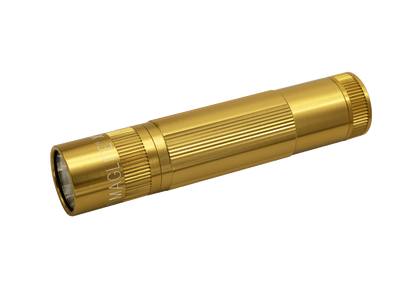 Gold Maglite XL50 LED flashlight angled across its white presentation box