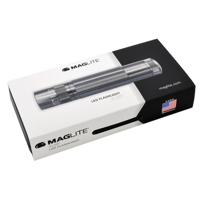Angled view of Maglite XL50 LED flashlight on its packaging box with logo and US flag graphic