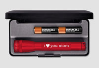 Red Mini Maglite flashlight with i heart you mom inscription in a foam case with two Duracell batteries